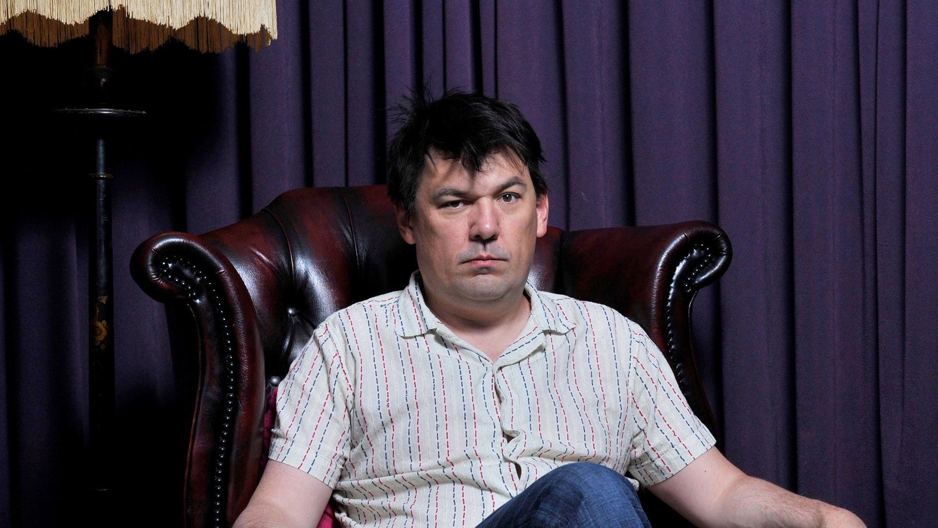 Graham Linehan sitting down