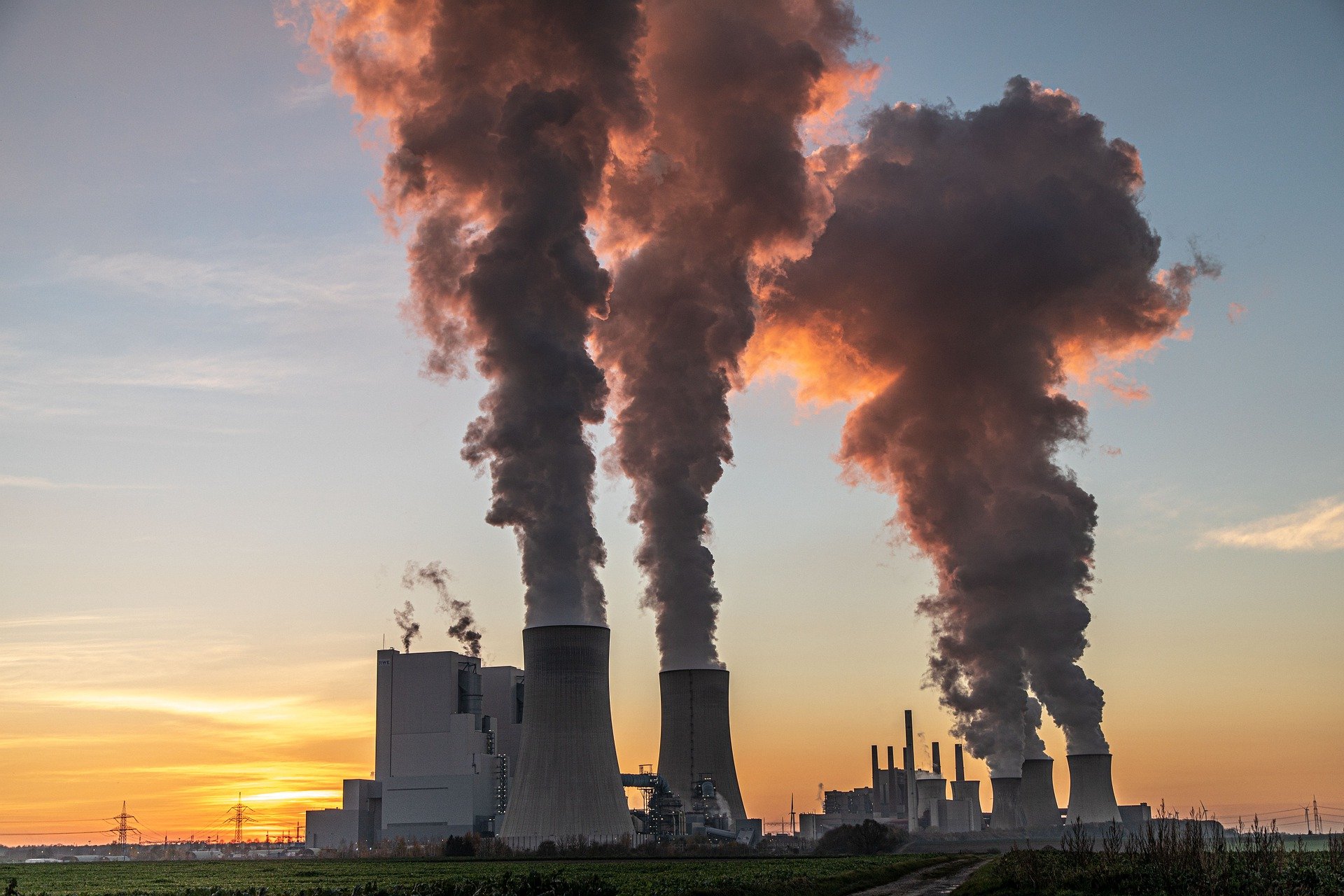 Power plant with smoke coming out of chimneys.