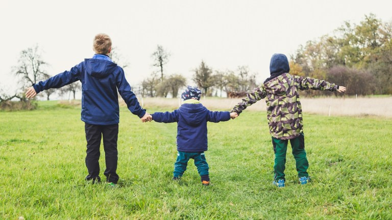 three children holding hands