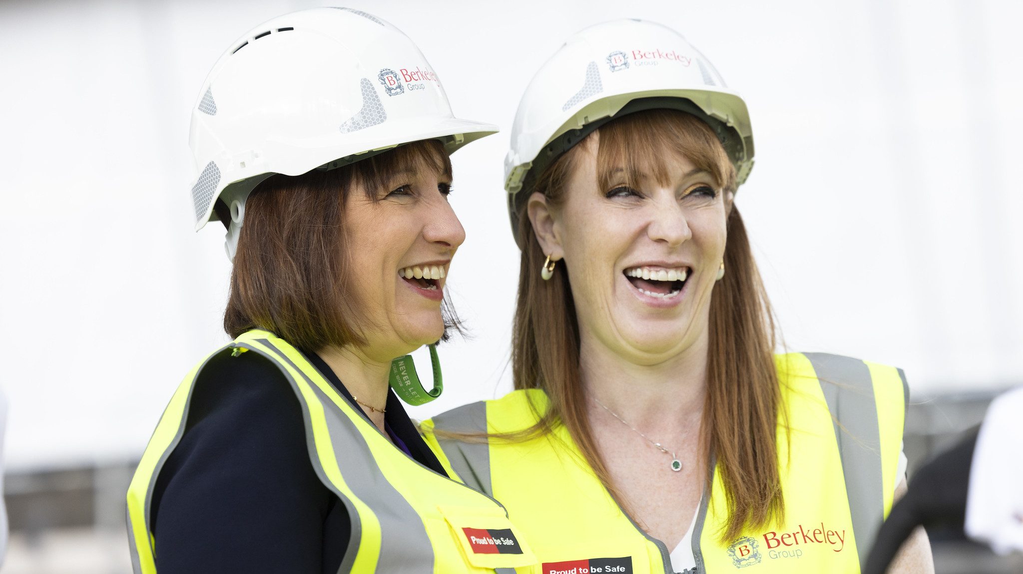 Chancellor Rachel Reeves and deputy prime minister Angela Rayner laugh while wearing hard hats