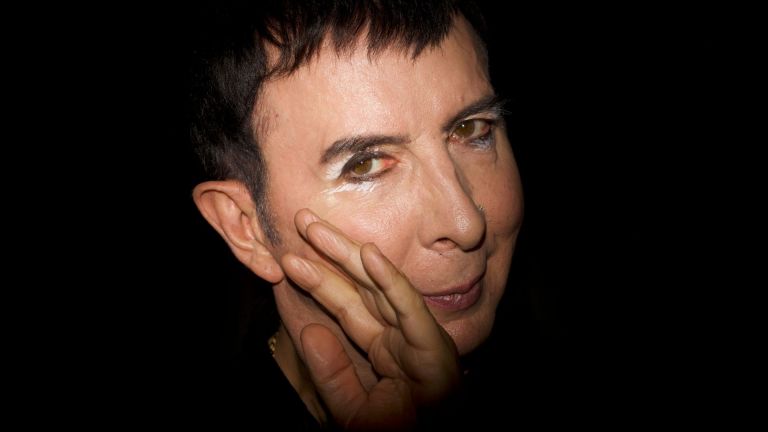 English singer Marc Almond in a low-lit photo with a black background