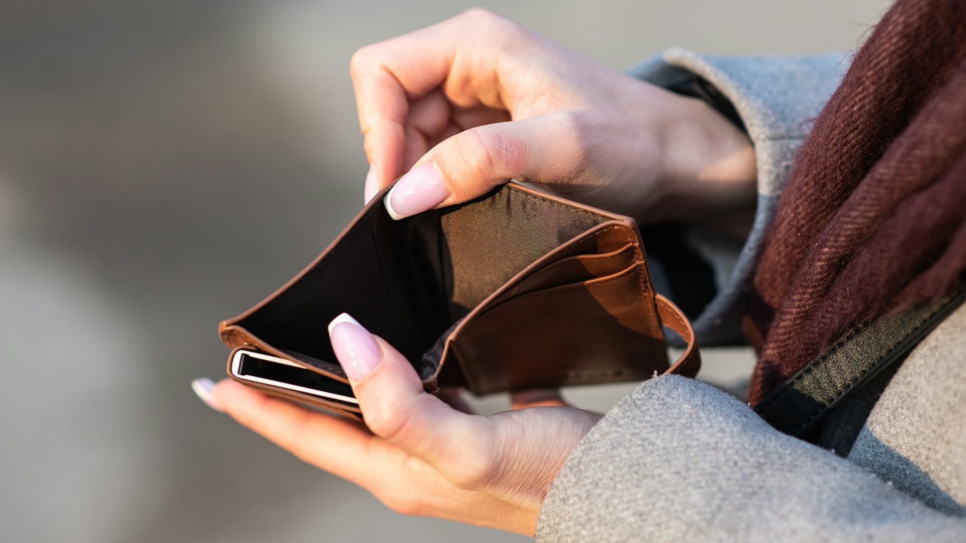 A pair of hands holding open an empty wallet. Thousands of Brits are in need of help with rental arrears