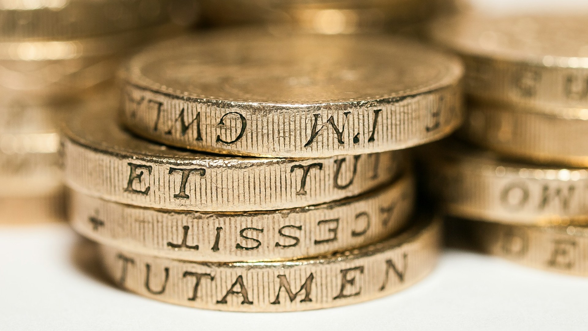 a pile of pound coins. deposit protection scheme