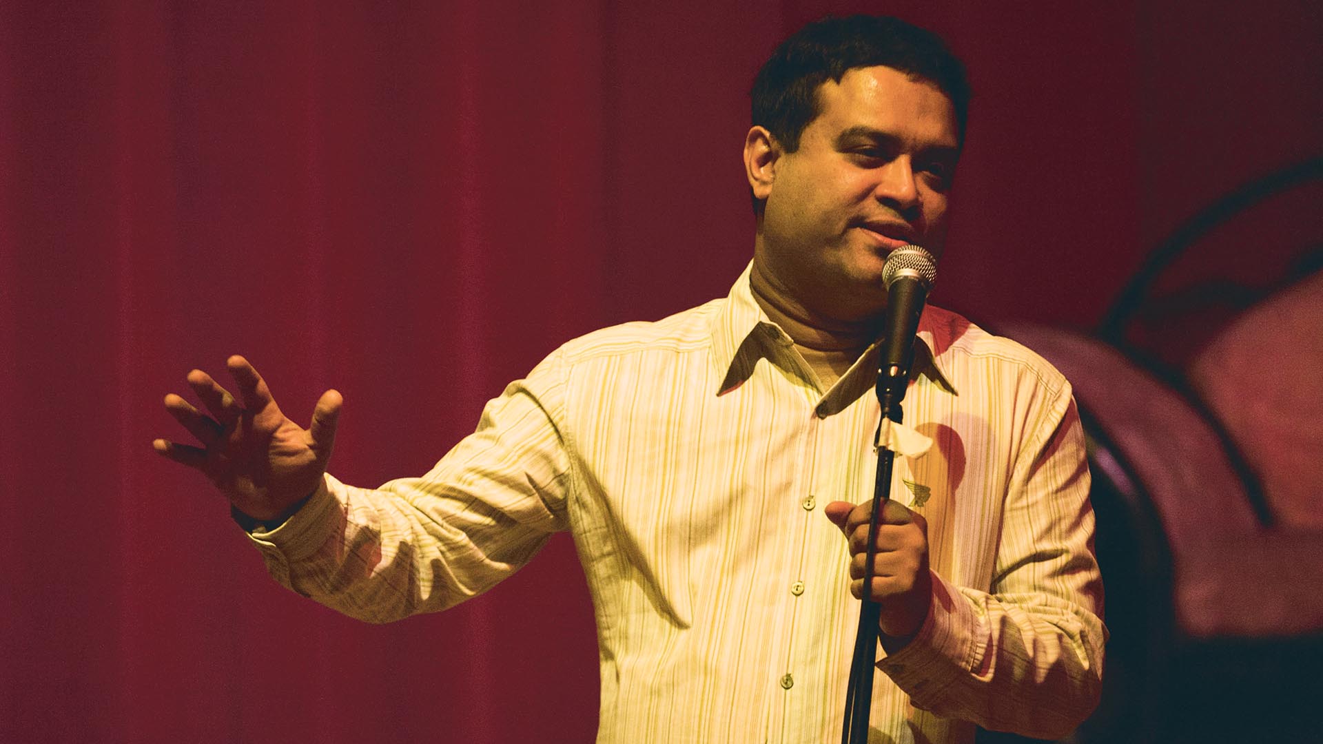 Paul Sinha performing stand-up in London in 2012