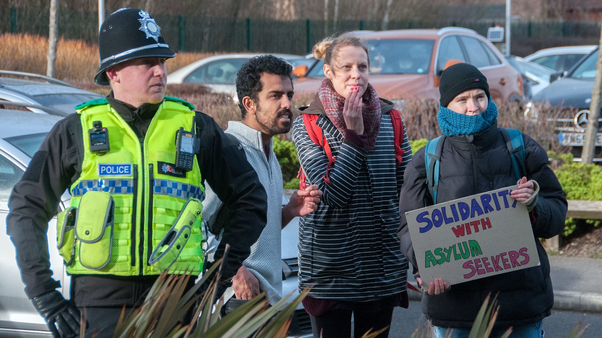 Counter-protesters react to a far-right protest outside an asylum seeker hotel