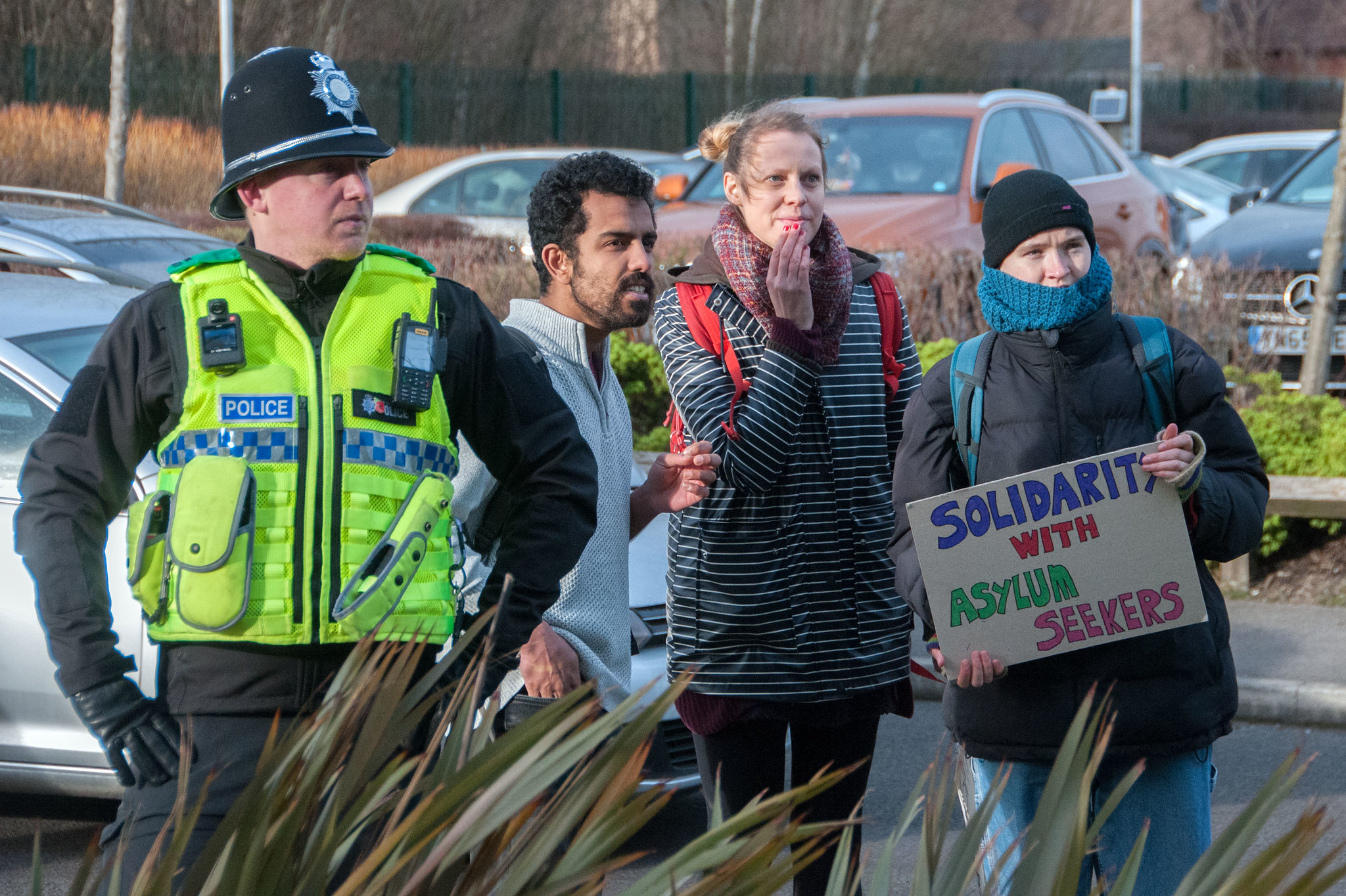 Counter-protesters react to a far-right protest outside an asylum seeker hotel