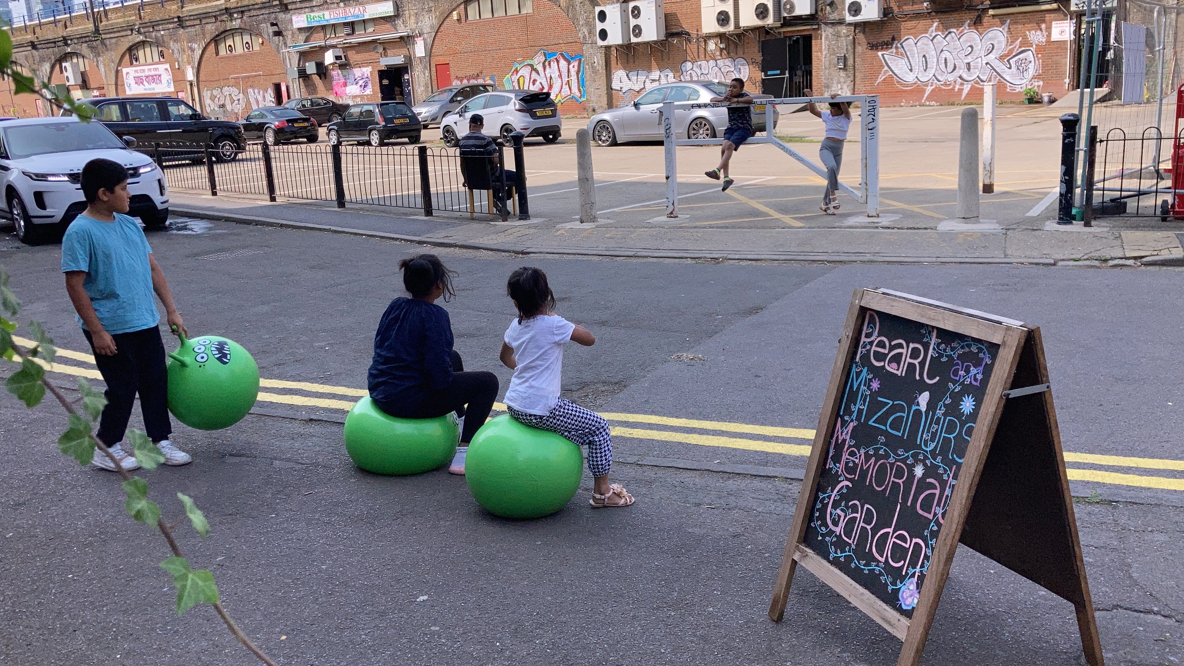 children on space hoppers next to Shadwell Overground station, east London