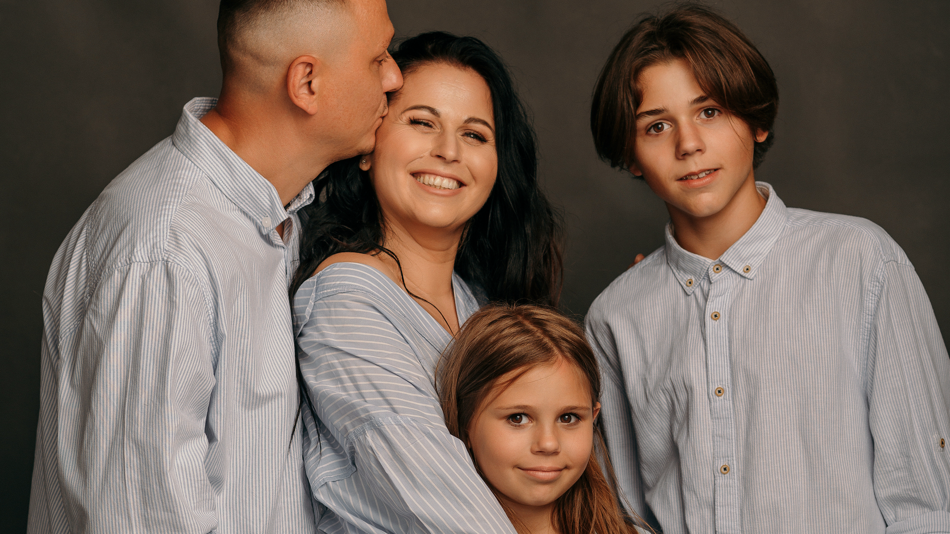 Ulyana Travola alongside her husband and children, who are still in Ukraine