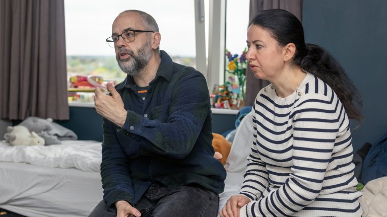 Couple Russ and Selma sitting in the Travelodge where they were placed by their local council after experiencing homelessness