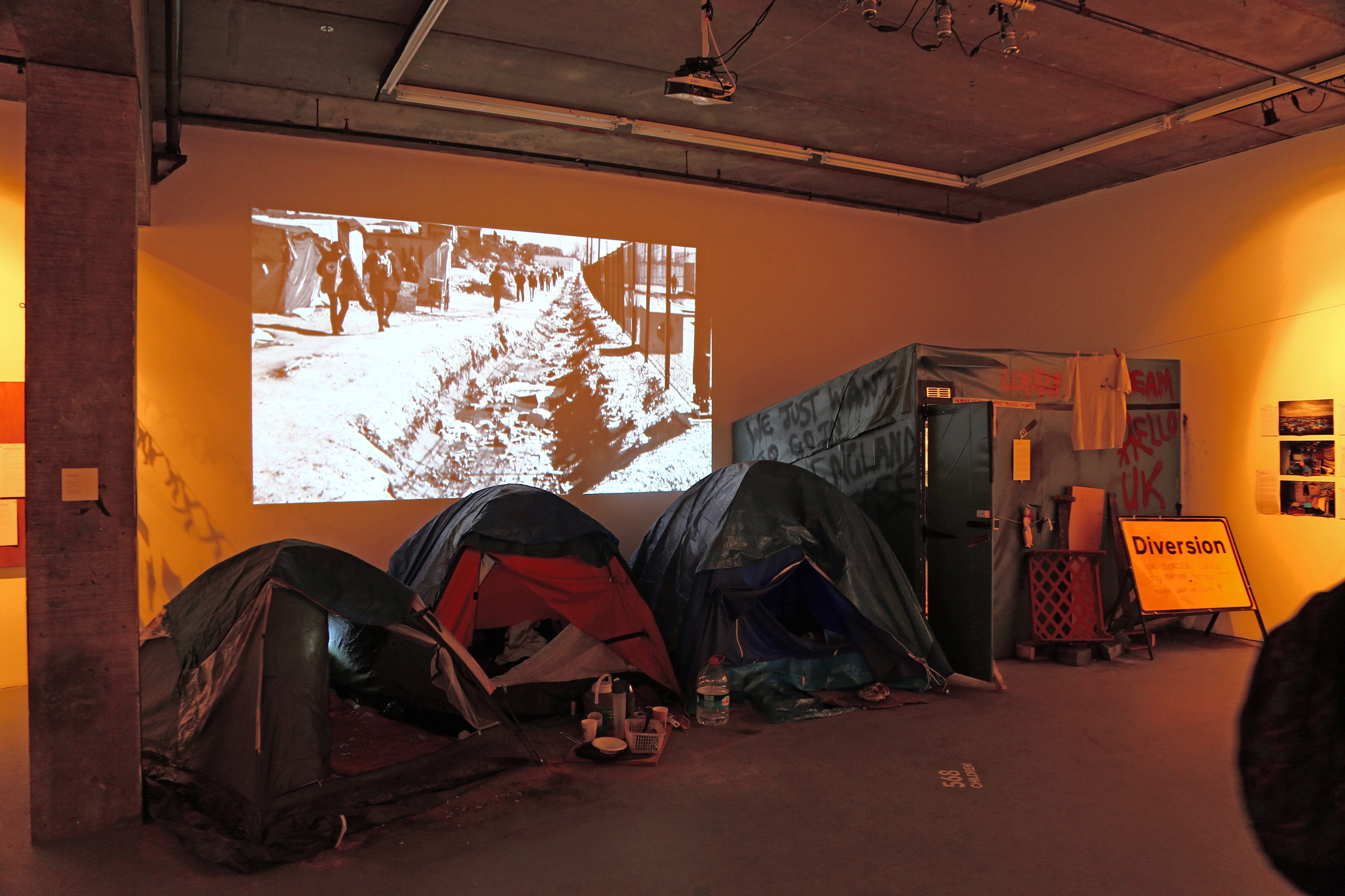 Tent installation showcasing stories, artwork and sounds from the former refugee camp in Calais, from the Migration Museum's All Our Stories exhibition