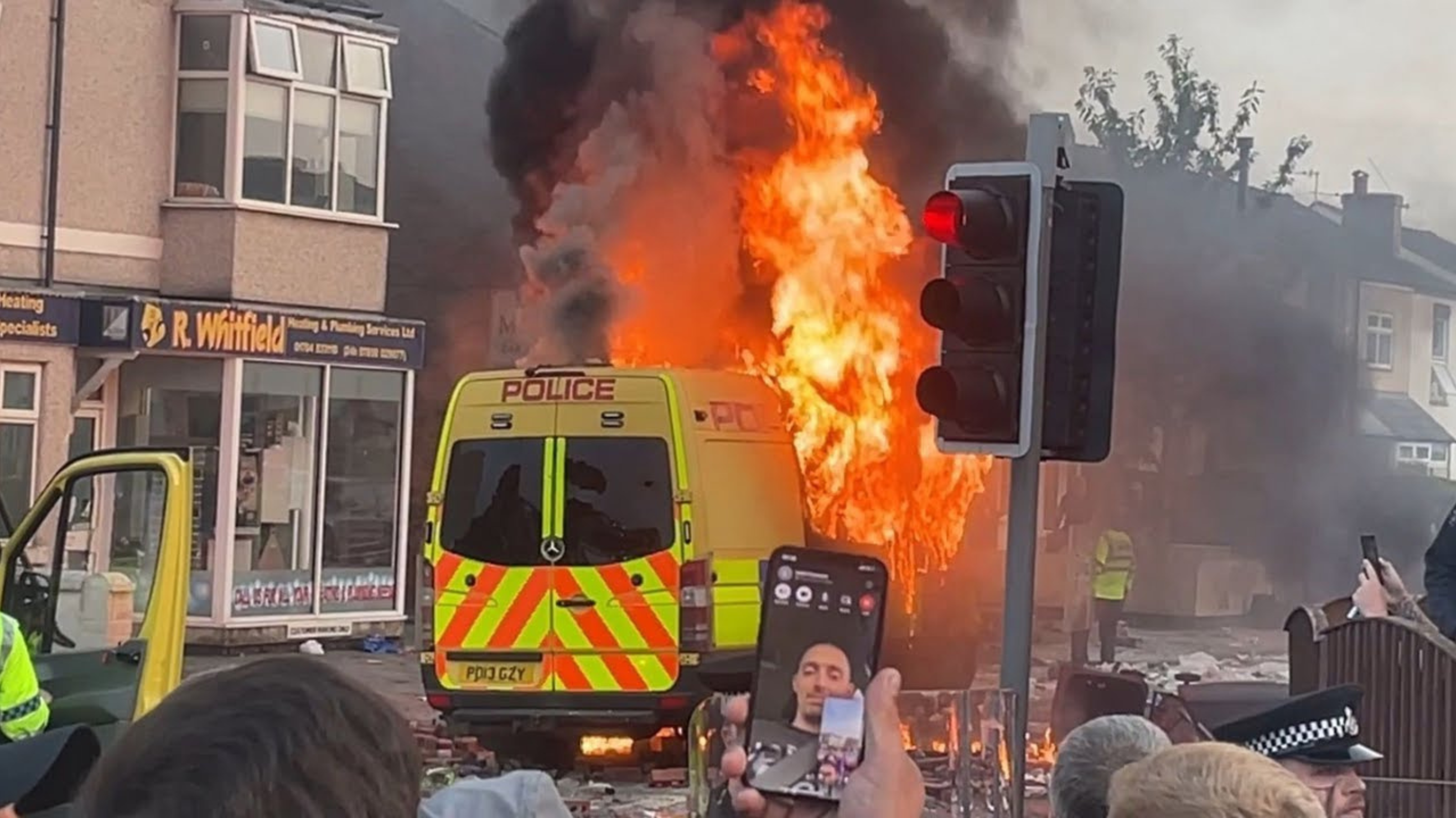 UK riots: A police riot van burns at a far-right riot in Southport