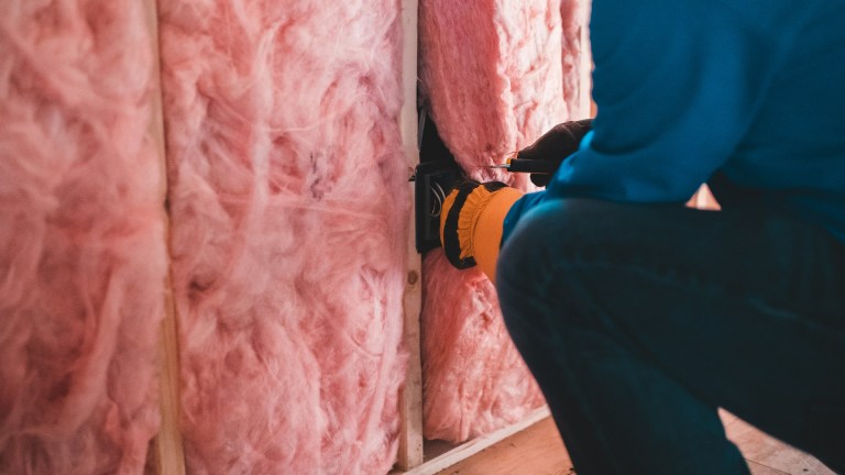 a construction worker installing insulation