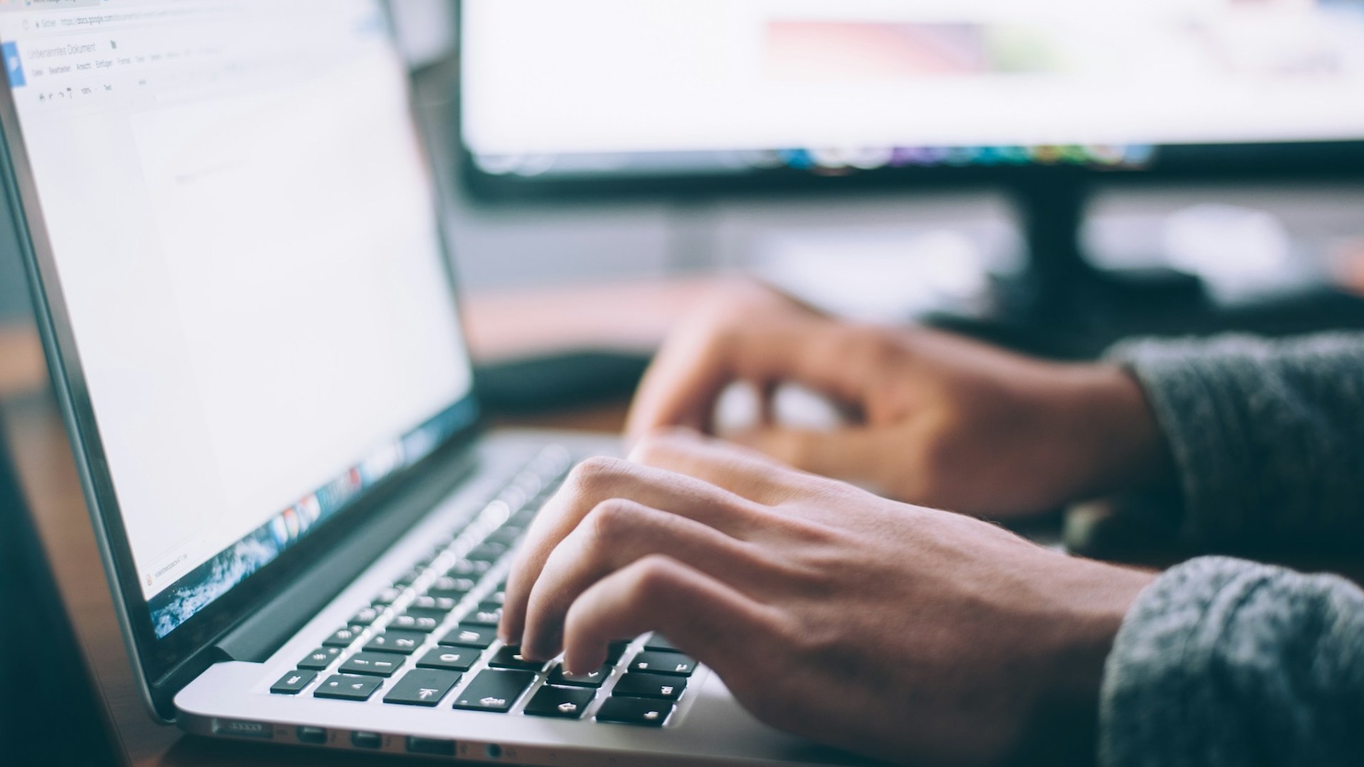 Hands typing on a keyboard. landlord reference letter