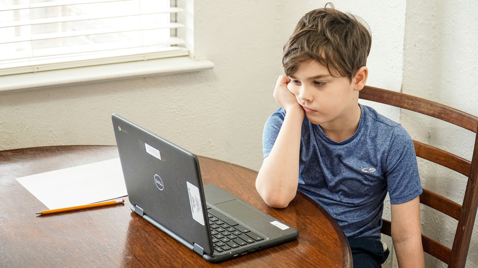 A child looking at a laptop computer