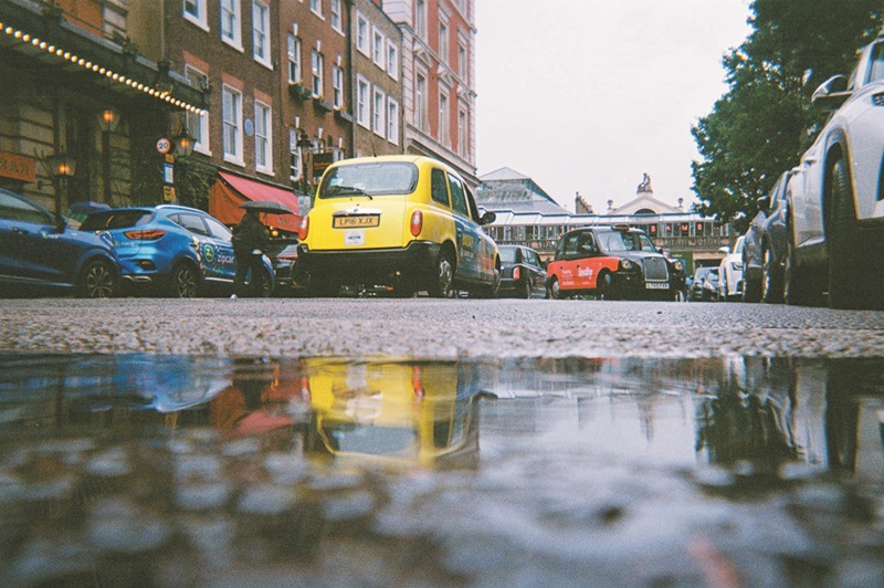 a London taxi reflecting in a puddle