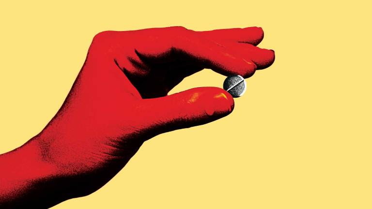 a red hand holds a pill on a yellow background