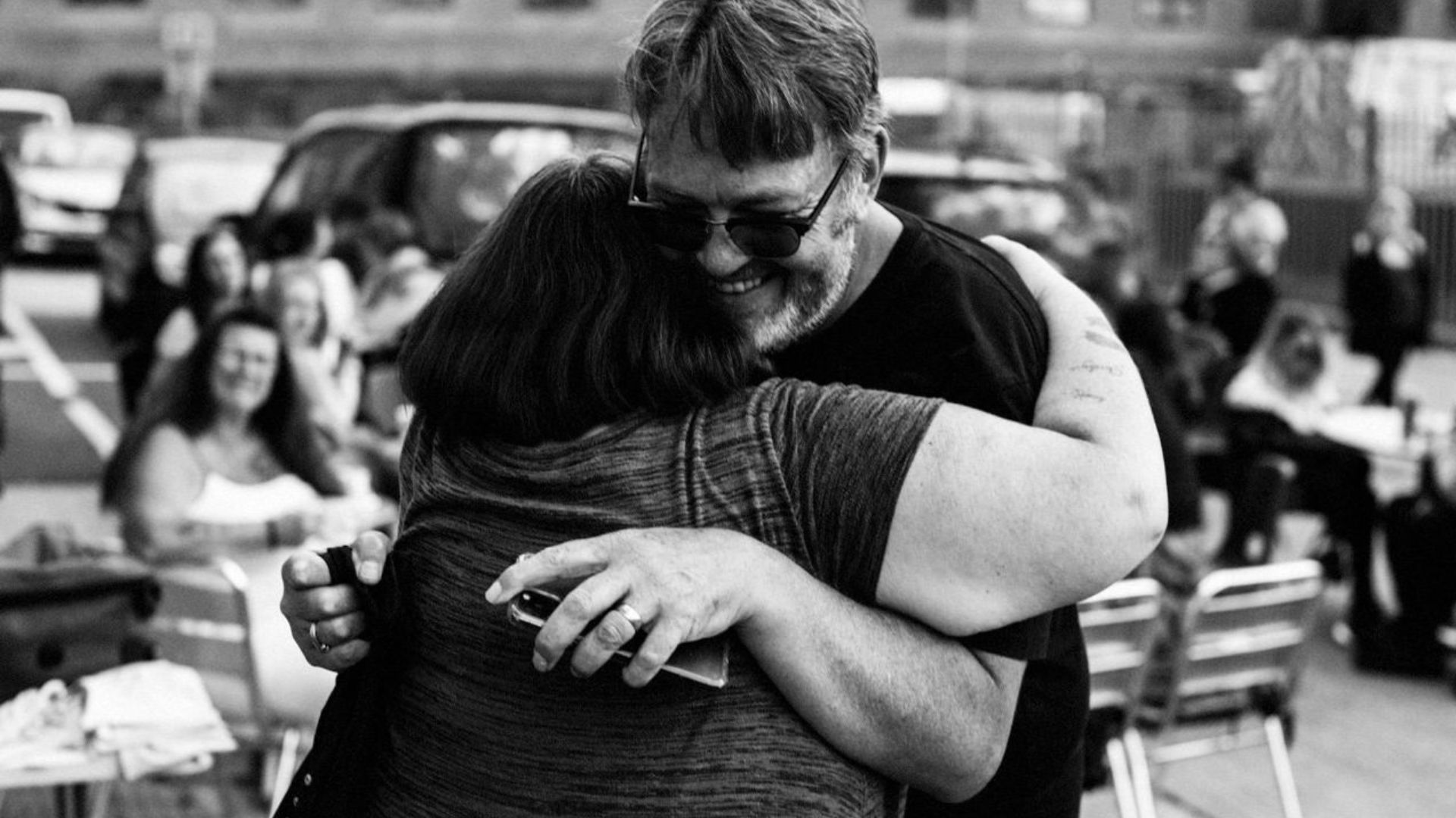 Photo of man hugging a woman to illustrate a story about the Haircuts 4 Homeless charity