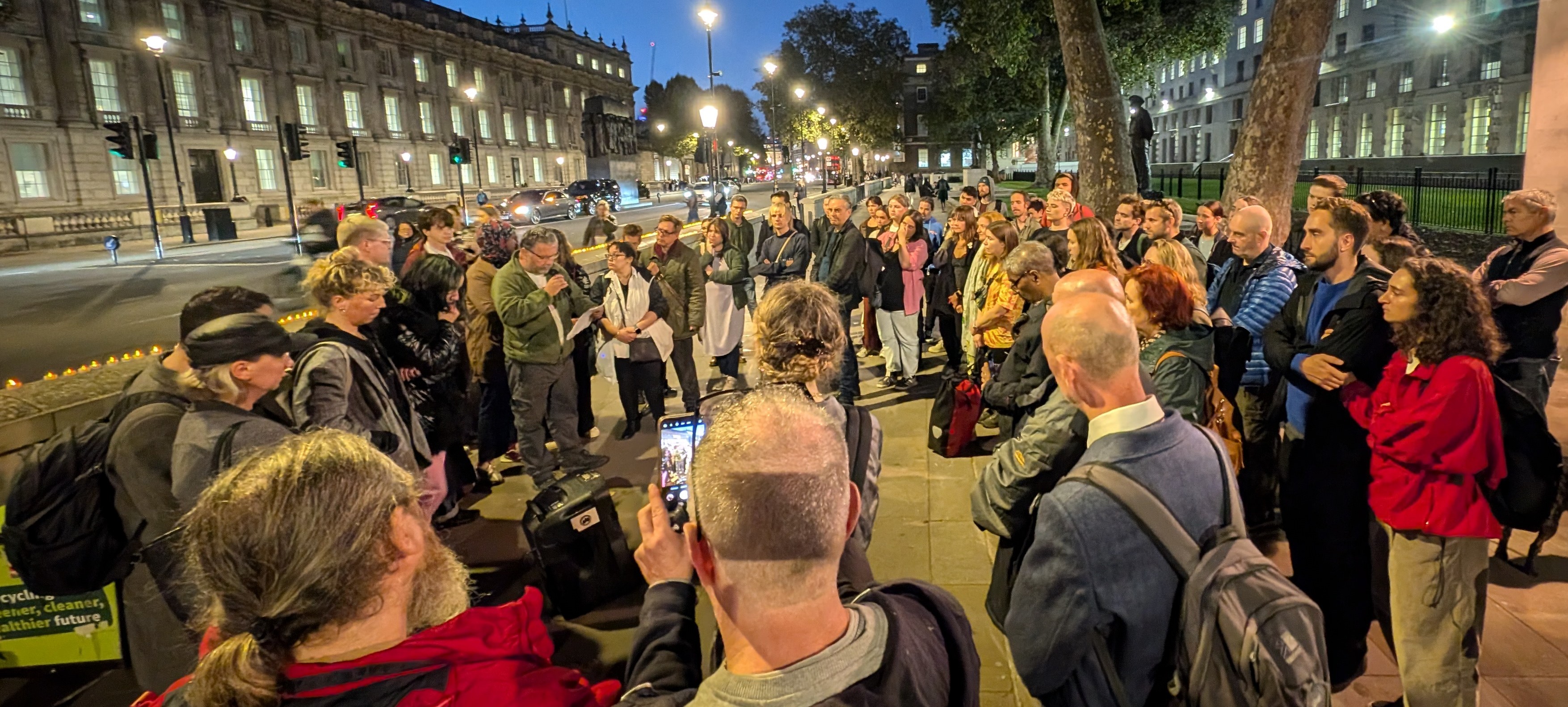 People at a vigil outside Downing Street for those who died while experiencing homelessness.