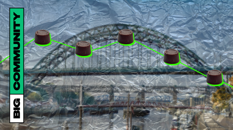 Some rolos are arranged in a line graph in front of the Tyne bridge