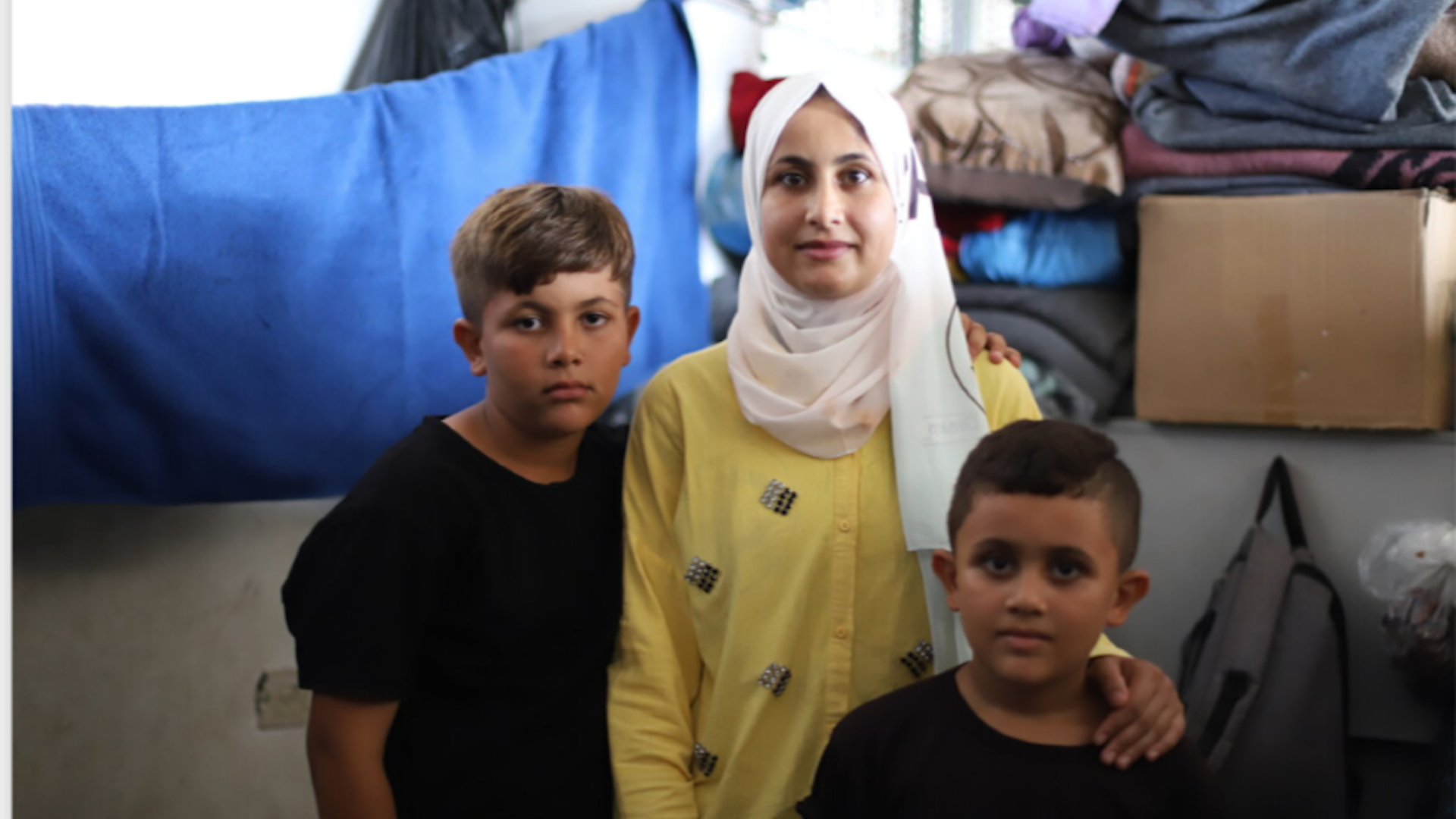 Shurooq and her children in the school-turned-shelter where they are living.