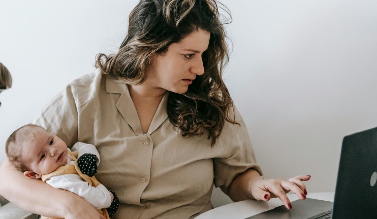 mother and baby looking worried at laptop