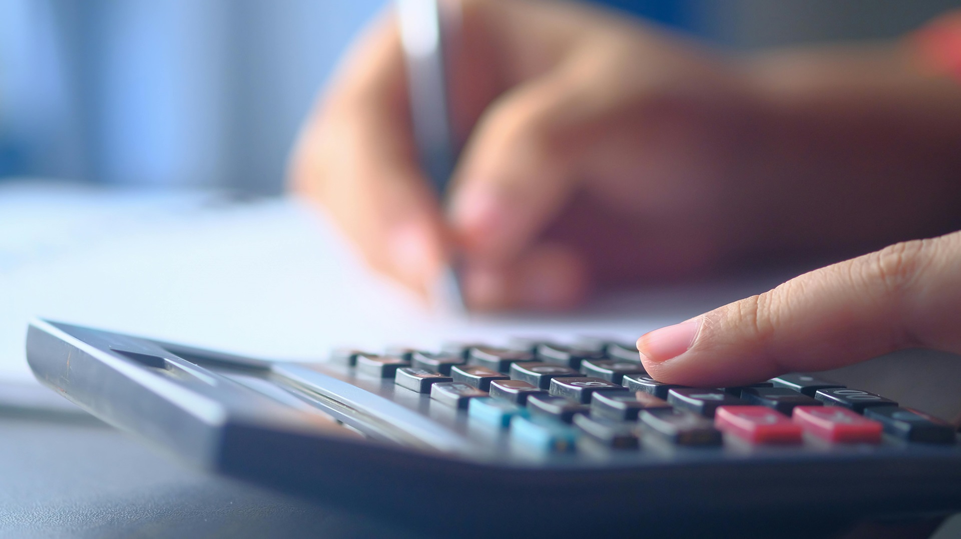 a person's hands on a calculator