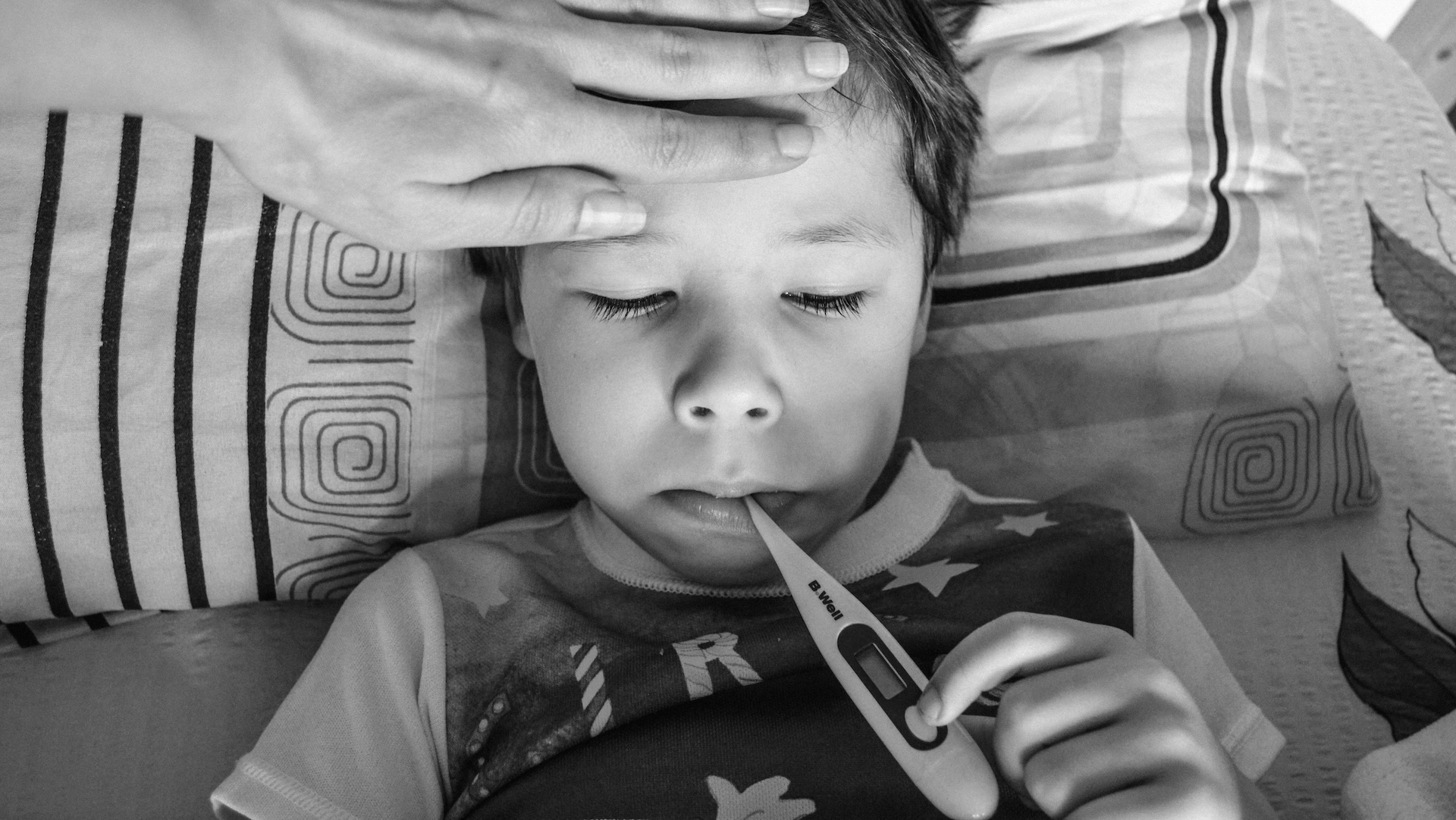 child with a thermometer in his mouth