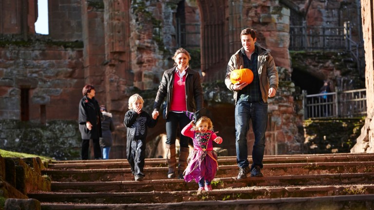 family at kenilworth castle, holding a pumpkin