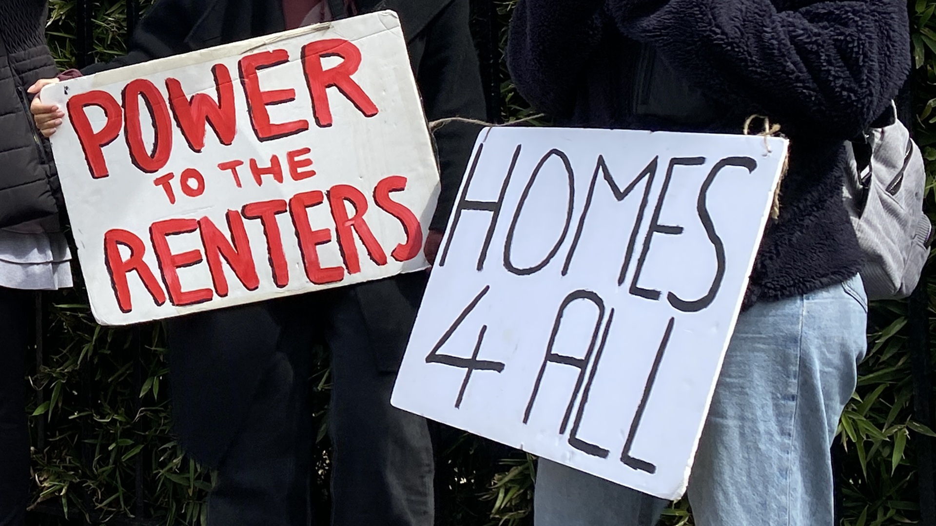 placards reading 'Power to the Renters' and 'Homes 4 All'