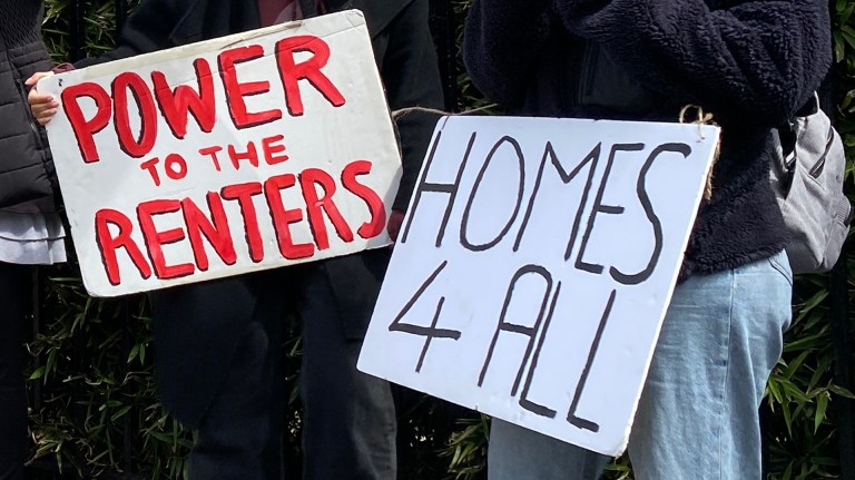 placards reading 'Power to the Renters' and 'Homes 4 All'