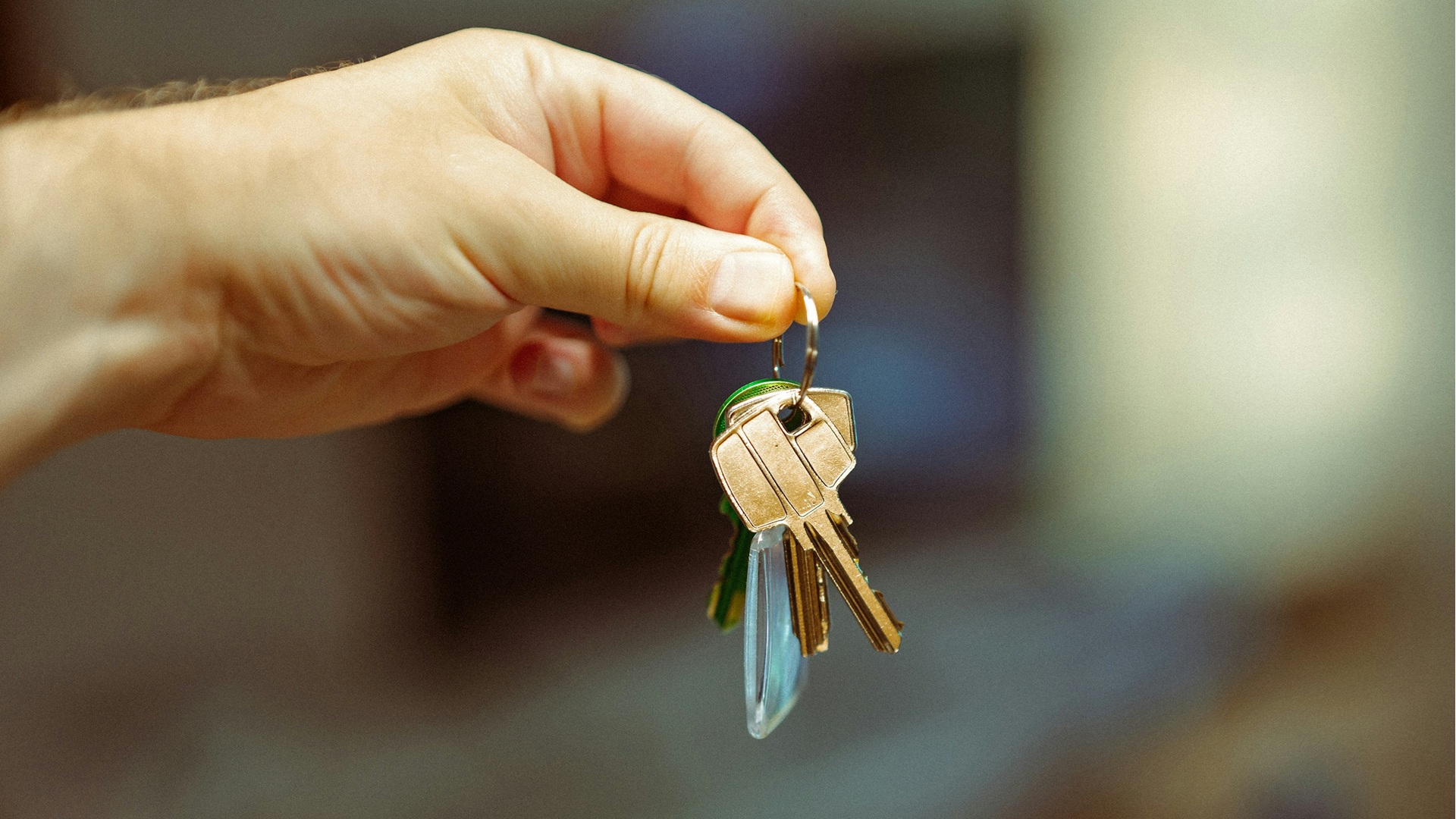 a hand holding house keys