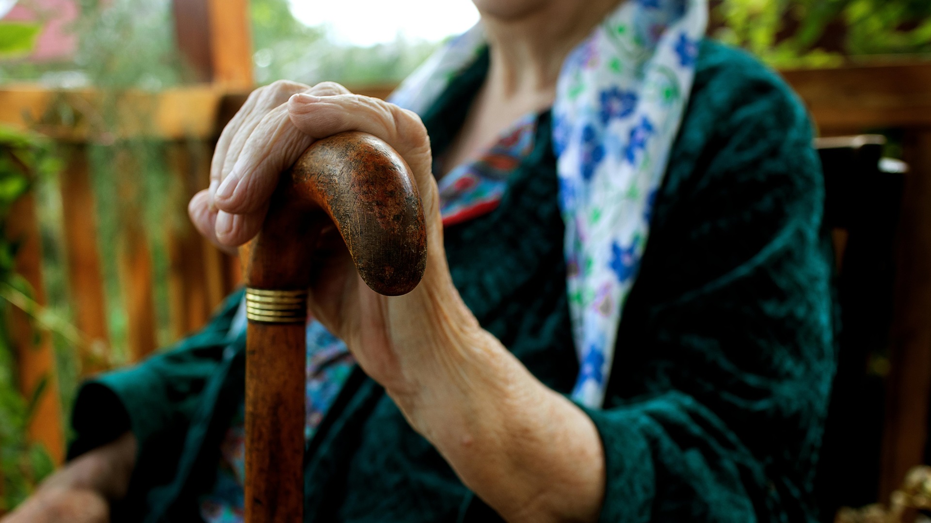 a pensioner holding a walking stick