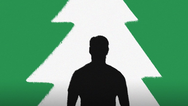 A silhouette of a man in front of the shape of a Christmas tree