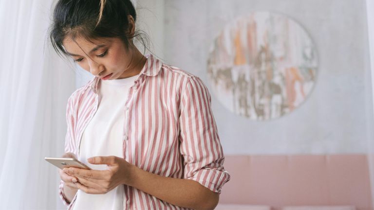 Stock photo of a teenage girl using a smartphone