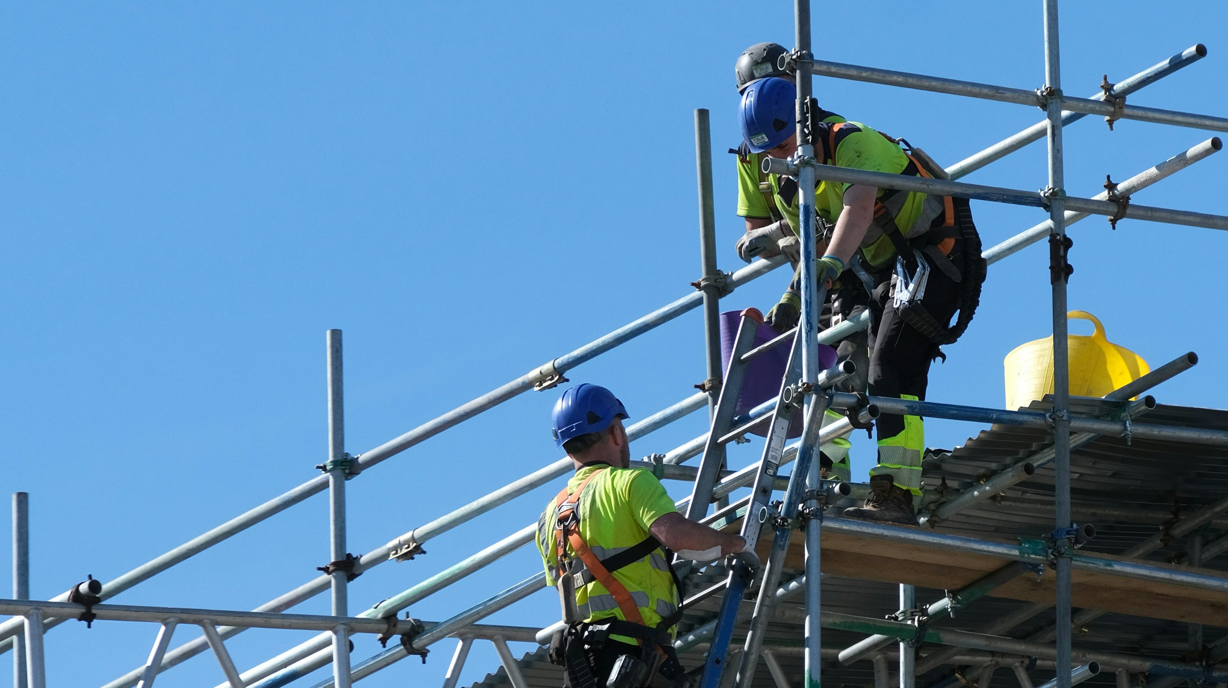 two builders on scaffolding