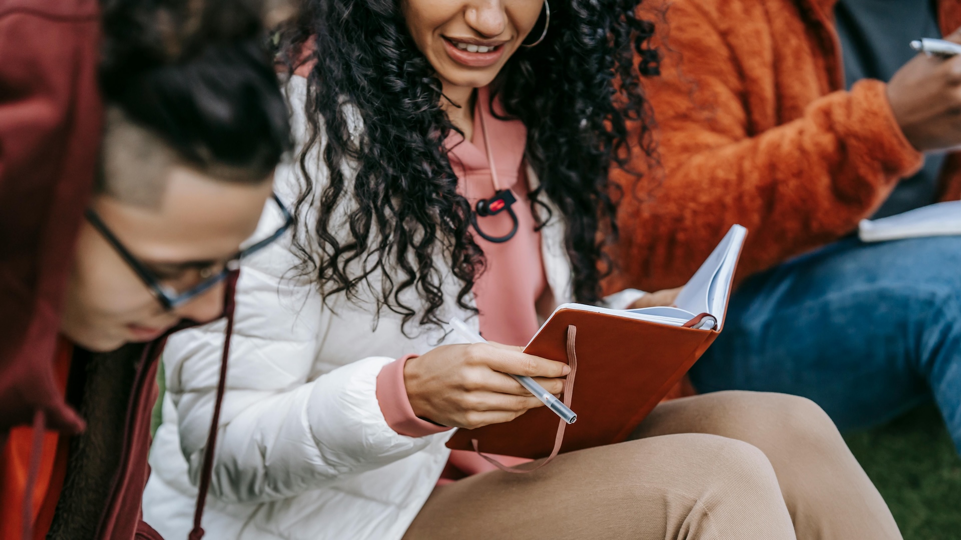 a group of people reading and writing