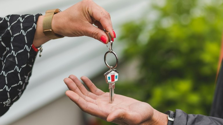 two hands holding keys