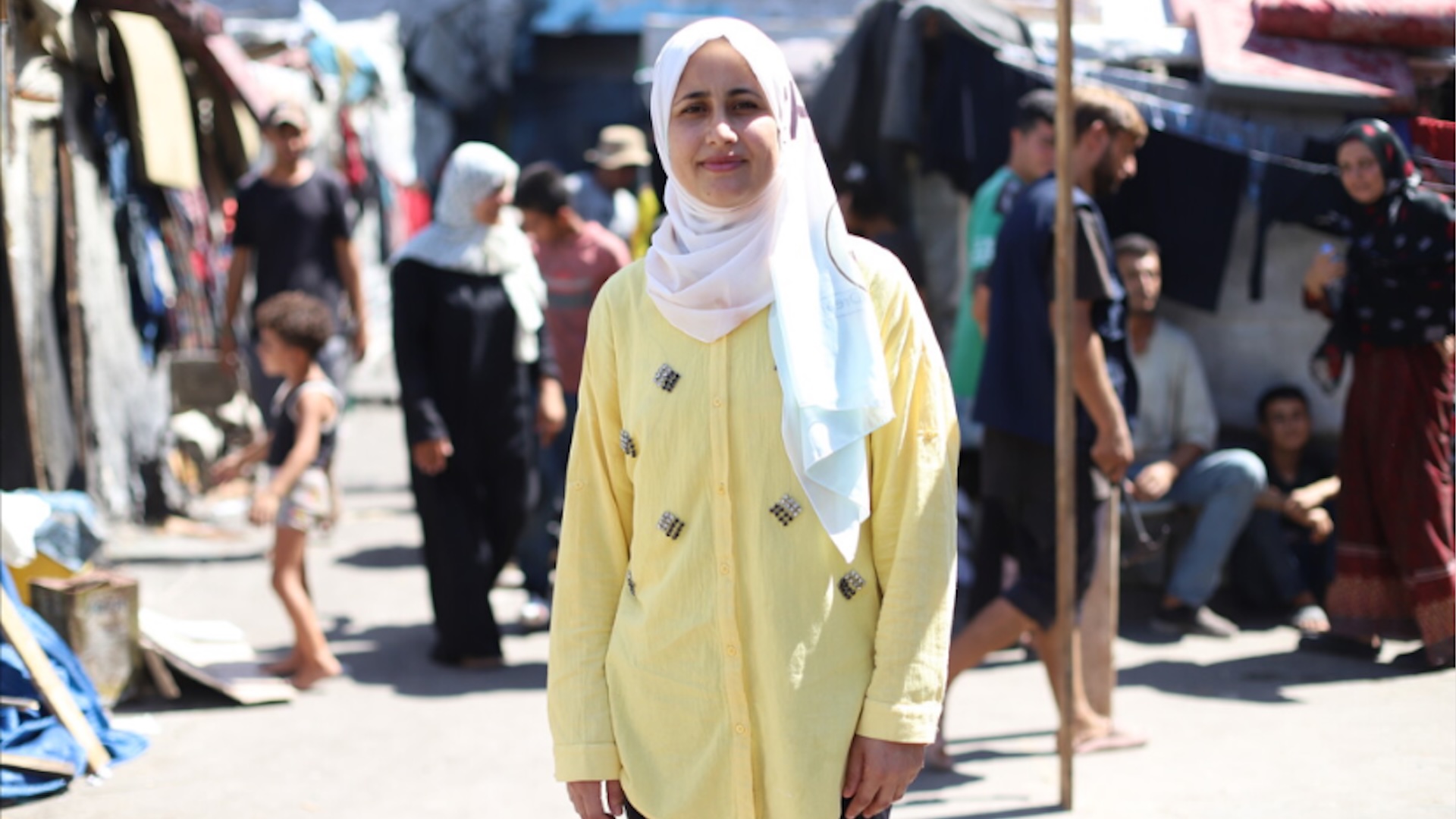 Image of Shurooq, a 31-year-old displaced mother, who was forced to flee from the north of Gaza at the start of the war and is currently sheltering in a school with her family