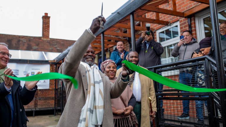 Levi Roots cuts the ribbon to launch the INI Food and Wellbeing Centre. To his right is Sistah Stella Headley and to his left is Jean-Michel Grand, the chief executive of Action Against Hunger UK.