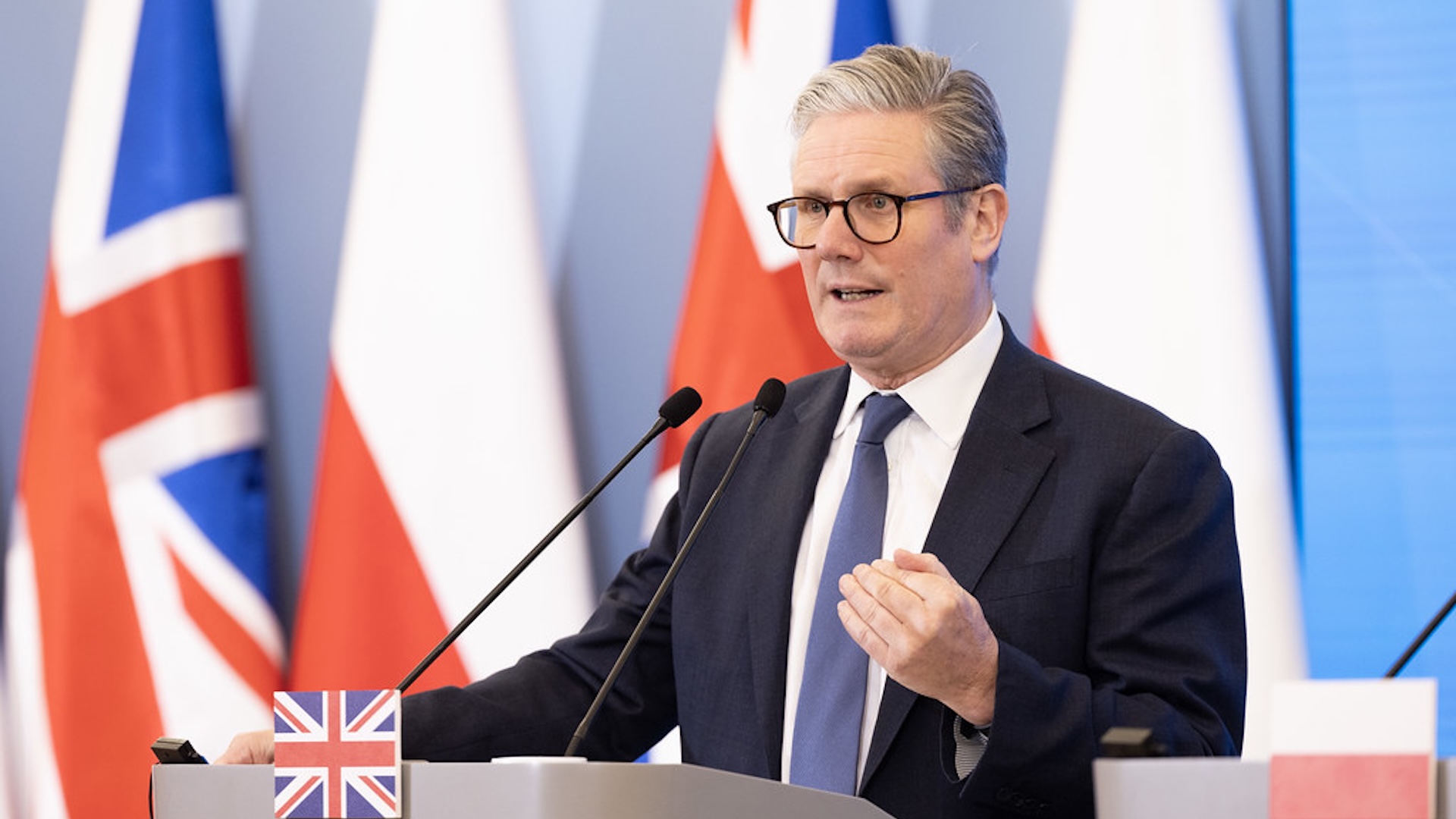 Keir Starmer at a lectern in front of UK flags