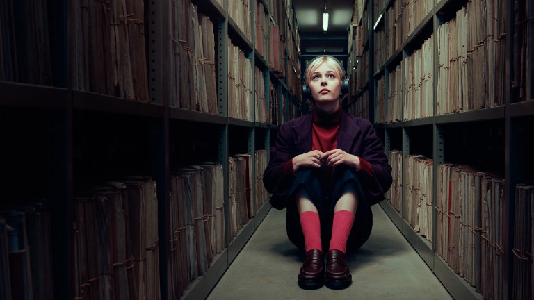 Ella Maisy Purvis in the role of Patience Evans in Channel 4 drama Patience. IN this picture she is sitting on the floor in the Police Records office where she works...