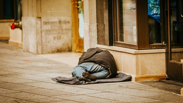 a person experiencing homelessness on the street