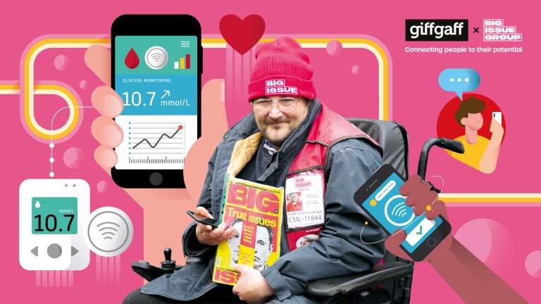 A Big Issue vendor named James sits smiling in his wheelchair, holding magazines and a phone. He wears glasses, a red Big Issue beanie, and a dark jacket. The image is surrounded by illustrated elements including a large smartphone displaying glucose monitoring data (showing 10.7 mmol/L), hearts, and cartoon figures using phones. The background is pink with yellow and white decorative lines. The giffgaff and Big Issue Group logos appear in the top right, with the tagline 'Connecting people to their potential'