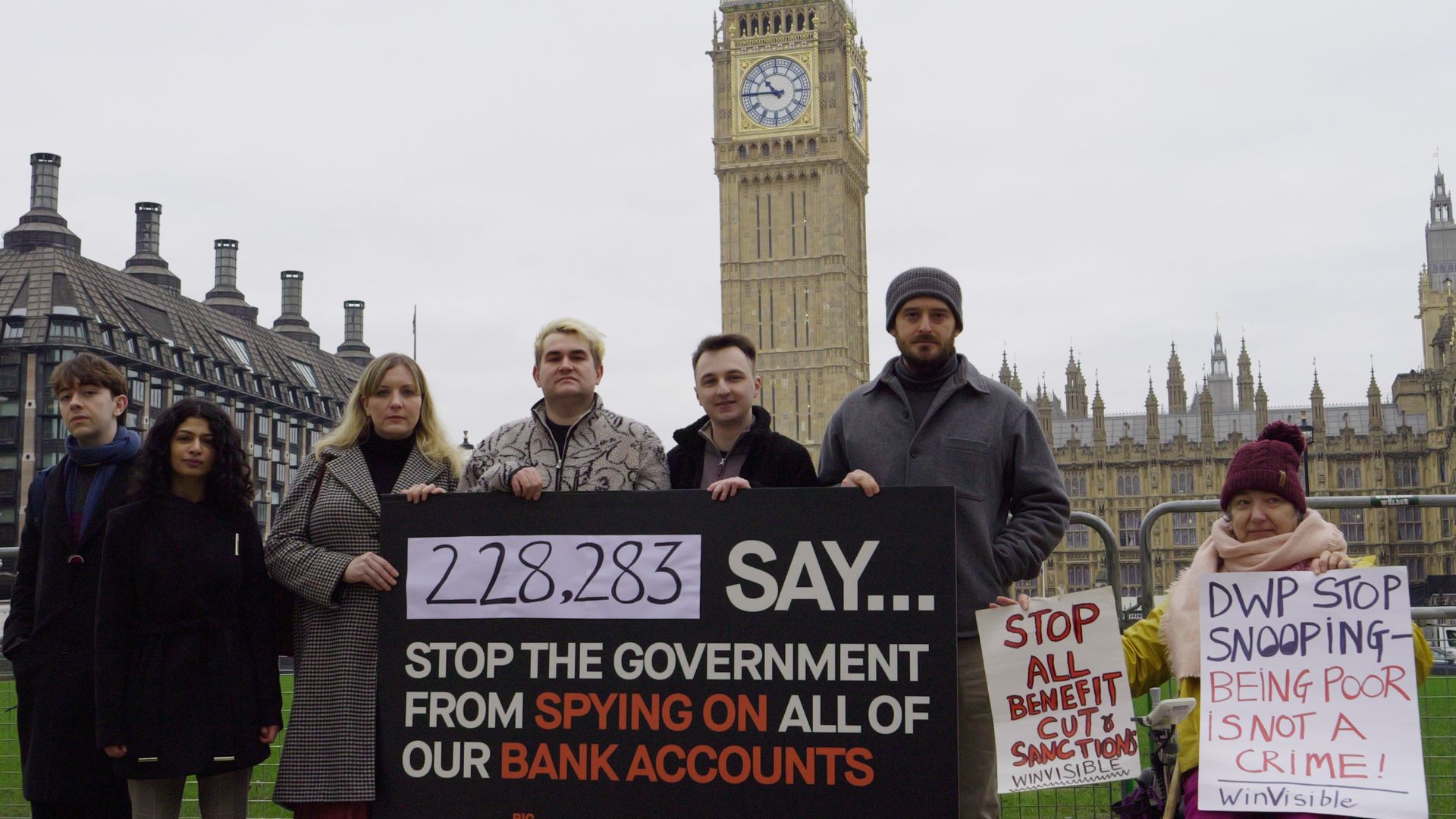 A group of seven campaigners from Big Brother Watch stand outside Parliament to protest the Public Authorities (Fraud, Error and Recovery) Bill