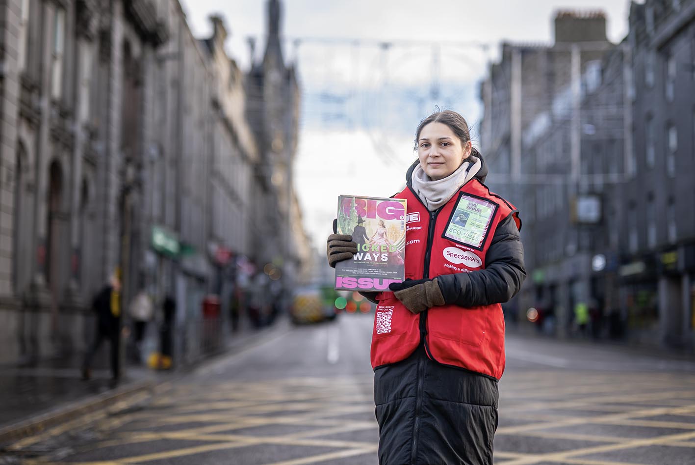 Big Issue vendor Pamela Milac stands on her pitch in Aberdeen, Scotland.