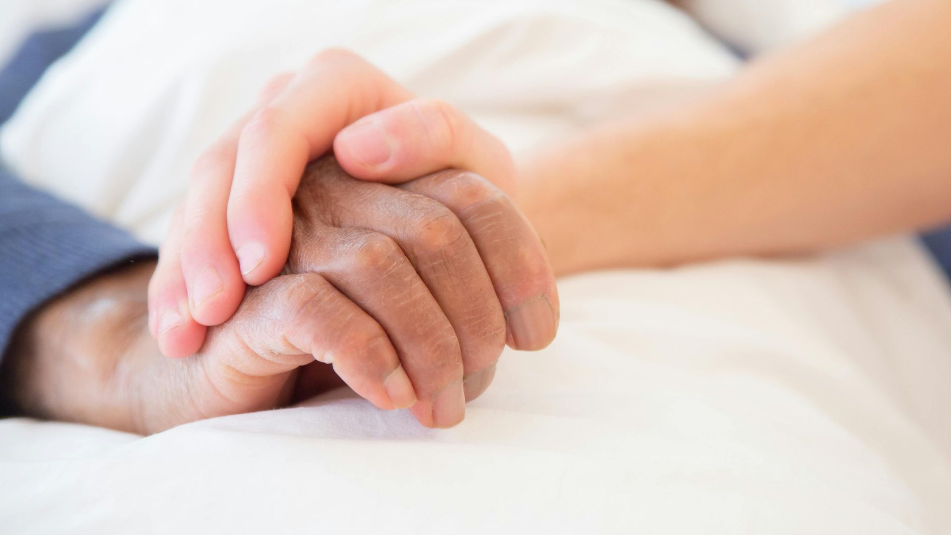 Person holding somebody's hand in hospital