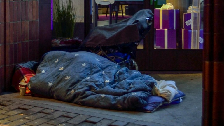 a person experiencing homelessness sleeping rough on the streets